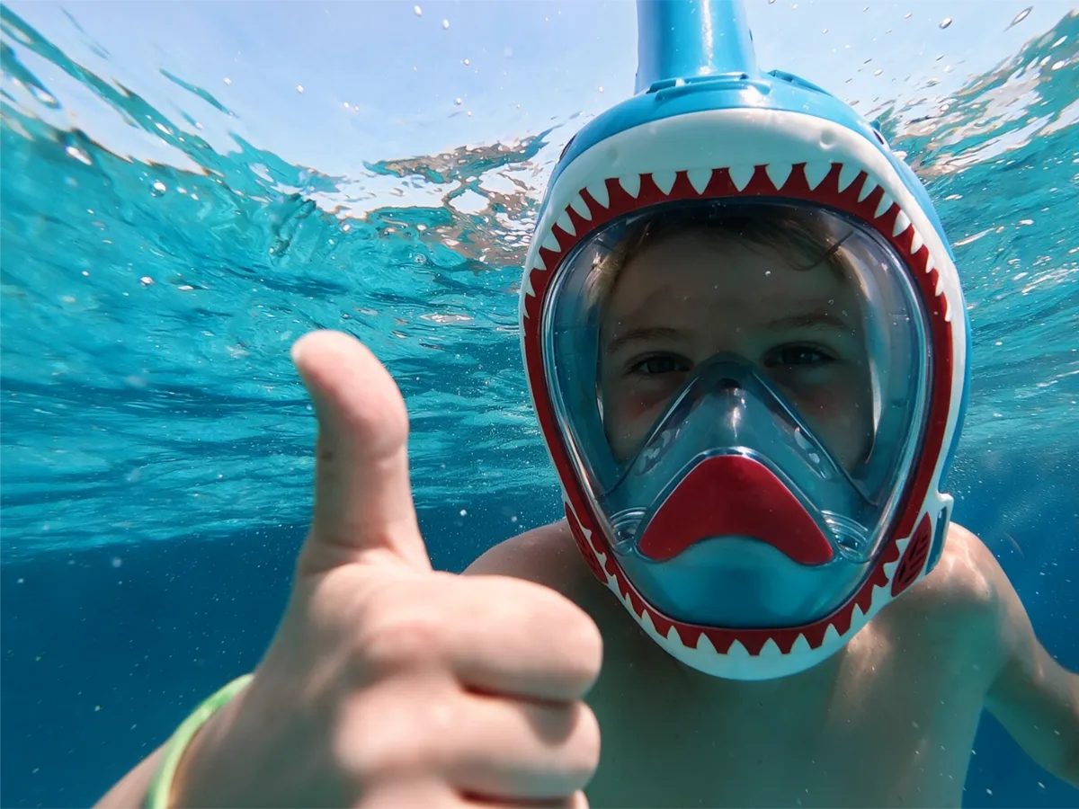 Child underwater wearing a NEBIBO snorkel mask
