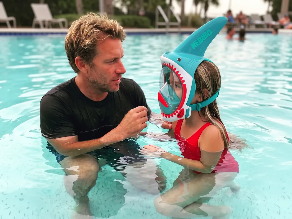 Parent helping a child with a NEBIBO snorkel mask